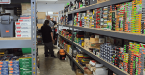 John McCabe, owner of Ammo Guy, helping out a customer in Santa Ana ammo store.